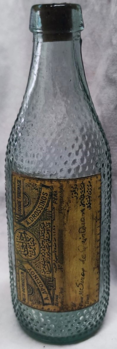 OSMANLI  A.DİRİNOS ECZANE İ KEBİR 25 LİK RAKI ŞİŞESİNDEN ECZA ŞİŞESİ ÖZEL EL YAPIM İLAC KOYULMASI İÇİN ÜC DİLDE YAZILMIŞ ORJINAL ETİKETLİ