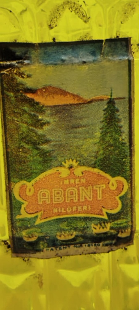 EYÜP SABRİ TUNCER METAL KAPAK YAZILI BEYAZ CAM  KOLONYA ŞİŞESİ ÜZERİ ETİKETLİ ORJINAL KAPAK